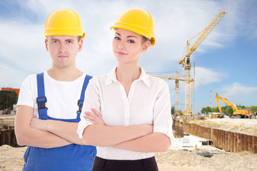 man builder and business woman architect in helmet