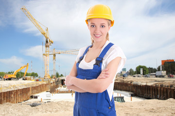 portrait of young woman in blue builder uniform