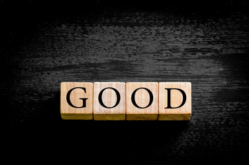 Word GOOD isolated on black background with copy space