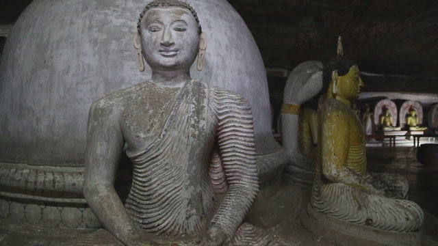 DAMBULLA, SRI LANKA - FEBRUARY 2014: Sitting Buddhas at the Golden Temple of Dambulla. The Golden Temple of Dambulla is a World Heritage Site in Sri Lanka.