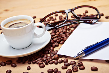 aromatic coffee on wood table with office supplies