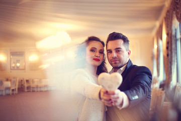 Happy couple holding heart shaped object