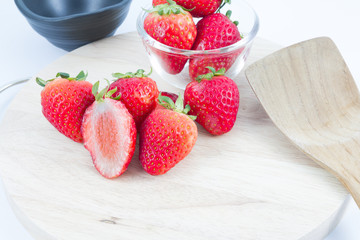 red strawberry on wood block