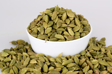cardamom on white cup with white background