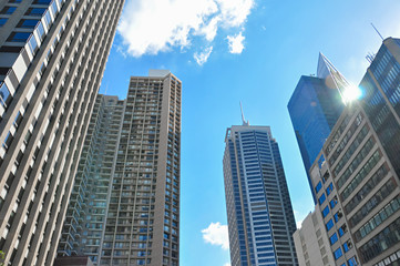 Fototapeta na wymiar Group of buildings in the city against blue sky background