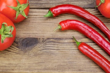 Three Fresh Red Hot Chili Peppers And Tomatoes