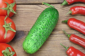 Fresh Tomatoes, Chili Peppers  and  Cucumber On Wooden Board