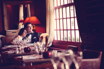 Bride and groom at restaurant, in a warm atmosphere