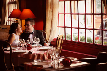 Bride and groom at restaurant, in a warm atmosphere