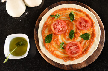 pizza and ingredients for pizza on wooden background