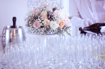 Many glasses of champagne with birdcage flower decor