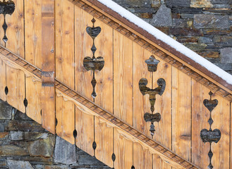 detail of decorative balustrade on mountain chalet in snow