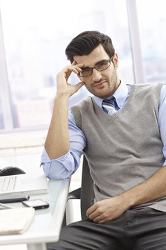 Portrait of casual office worker sitting at desk