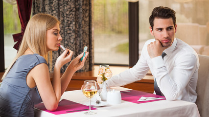 Young couple is getting bored and on first date