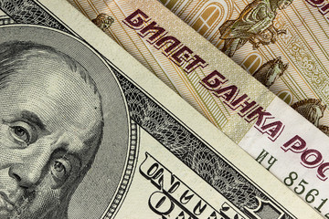 Background of US dollars and Russian rubles, close up