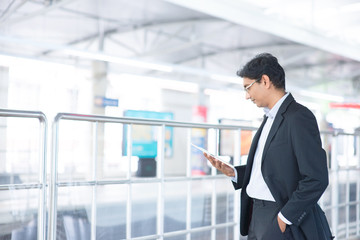 Fototapeta premium Man using tablet computer at railway station