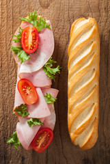 long baguette sandwich with ham tomato lettuce