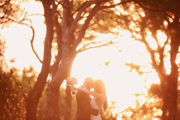 Bride and groom silhouettes in the sunlight