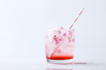 Fresh pink flower frozen in ice cubes for summer drinks