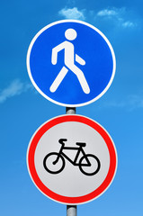 Road sign permission for pedestrians and bicycle ban on blue sky