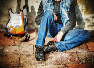 guitar and man against the wall