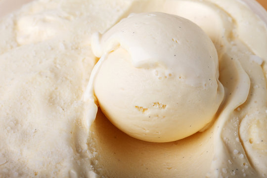 creamy vanilla ice cream scoop in a white cup