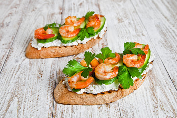 shrimp sandwich on a white wood table