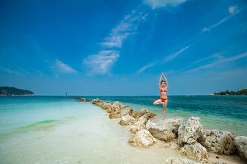Fototapeta na wymiar Summer yoga session on a beach