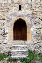 Fototapeta na wymiar Stairs and door ina stone wall