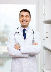 smiling doctor in white coat at medical office