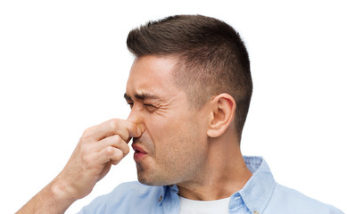 man wrying of unpleasant smell