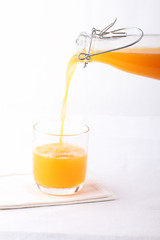 pouring orange into a glass