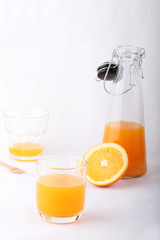 glass of orange juice and a bottle of orange juice