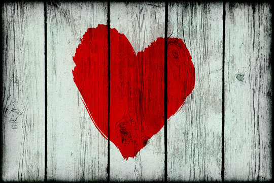 Red bright abstract heart on old wooden grunge wall