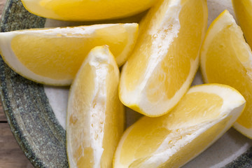 Yellow grapefruit slice on a plate.