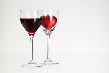 Wine glasses with red wine and heart