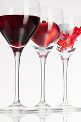 Wine glasses with red wine, heart and golf ball