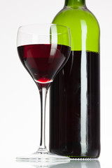 Wine glass and bottle with red wine