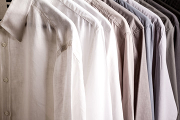 Several shirts on a hanger, background.