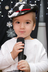 Adorable child singing (or talking) into a microphone.
