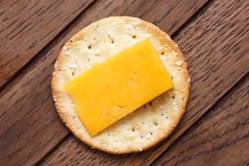 Crispy round cheese cracker from above. With cheese.
