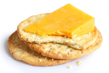 Three golden cheese crackers on white. With cheese.