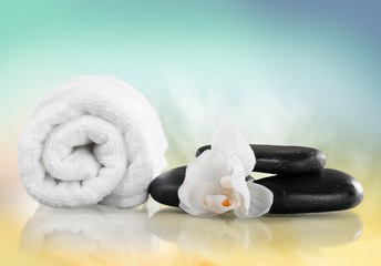 Obraz na płótnie Canvas Spa Treatment. Towel, gladiola and pebbles for massage