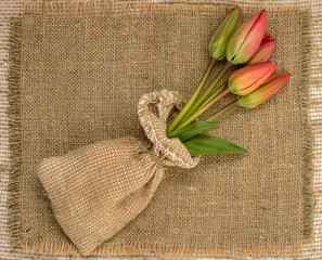 bouquet of red tulips on burlap background