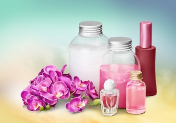 Fototapeta na wymiar Cosmetics. Pink soap bottles and flowers