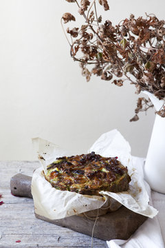 onions savoury cake on wooden cutting board with autumnal leaves