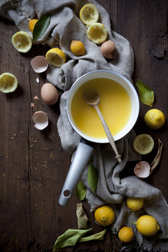 preparation of lemon curd with ingredients on wooden table