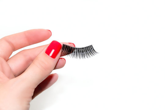 Female Hand is Keeping False Lashes. The Girl is Going to Attach