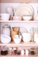 Kitchen utensils and tableware on shelves