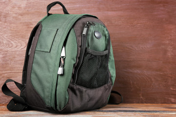 Backpack on wooden background